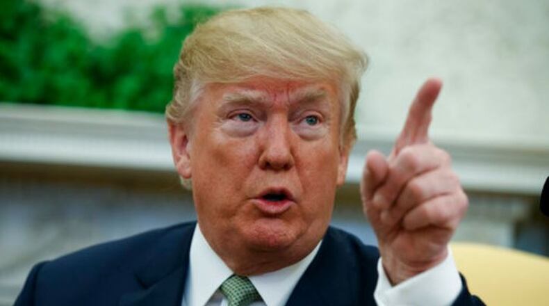 President Donald Trump talks with reporters in the Oval Office March 15, 2018. (AP Photo/Evan Vucci)
