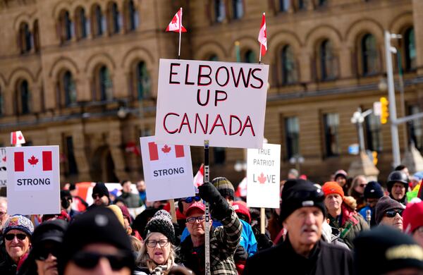 People participate in a rally in response to U.S. President Donald Trump's threats to Canadian sovereignty, on Parliament Hill in Ottawa, on Sunday, March 9, 2025. (Justin Tang/The Canadian Press via AP)