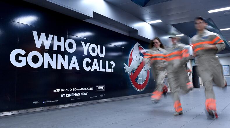FILE PHOTO: "Ghostbusters" fans run through a commuter tunnel at Waterloo Station on July 11, 2016 in London, England. Jason Reitman, son of the original film's director, has announced a new chapter of the classic comedy.