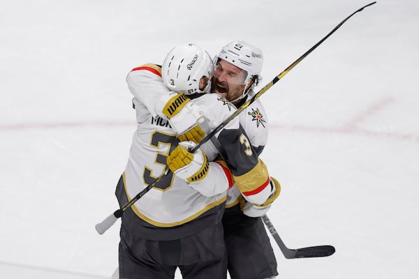 Vegas Golden Knights right wing Mark Stone (61) celebrates with defenseman Brayden McNabb (3) after scoring during the third period of Game 6 of a first-round NHL hockey playoff series against the Minnesota Wild, Thursday, May 1, 2025, in St. Paul, Minn. (AP Photo/Bailey Hillesheim)