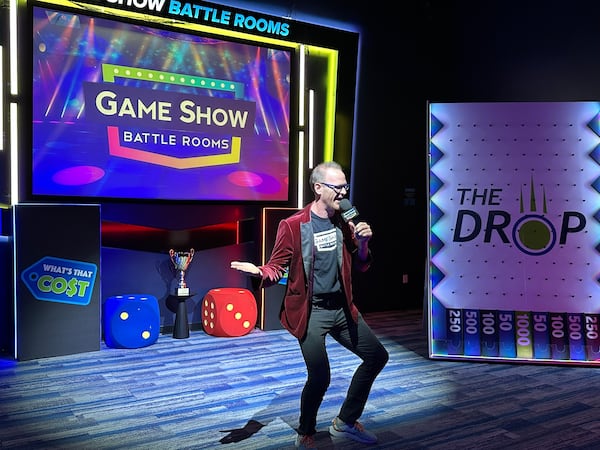 Conrad Davenport serves as a game show host at Game Show Battle Rooms on Saturday, May 16, 2026, in Dunwoody. (Rodney Ho/AJC)