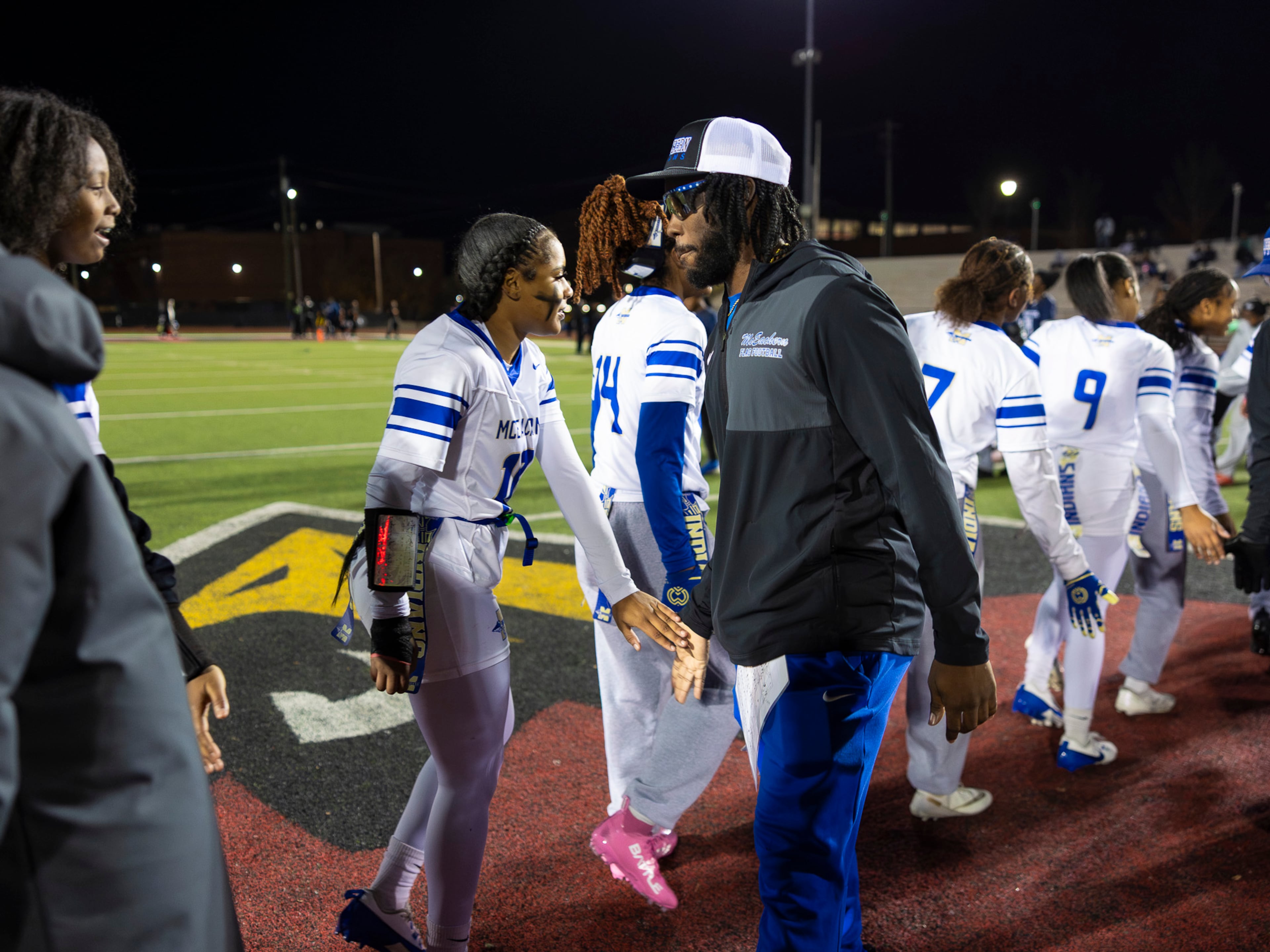 McEachern High School assistant coach and former "Freeze" runner Nigel Talton congratulates his team during a flag football game against Marietta at Osborne High School in Marietta on Monday, Nov. 17, 2025. (Oscar Guevara Saenz for the AJC)