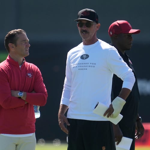 San Francisco 49ers head coach Kyle Shanahan, middle, watches players run drills during the NFL football team's training camp, Monday, Aug. 3, 2026, in Santa Clara, Calif. (AP Photo/Jeff Chiu)