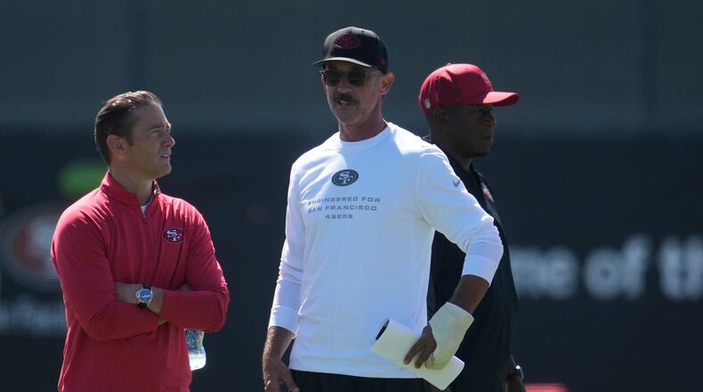 San Francisco 49ers head coach Kyle Shanahan, middle, watches players run drills during the NFL football team's training camp, Monday, Aug. 3, 2026, in Santa Clara, Calif. (AP Photo/Jeff Chiu)