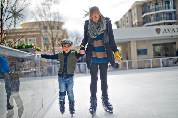 Kai Kapadia (left) holds hands with his cousin Szannlee Dickenson as they skate on the ice rink at Avalon in Alpharetta on Sunday, Nov. 30, 2014. The rink will be open most days through February 2015. JONATHAN PHILLIPS / SPECIAL