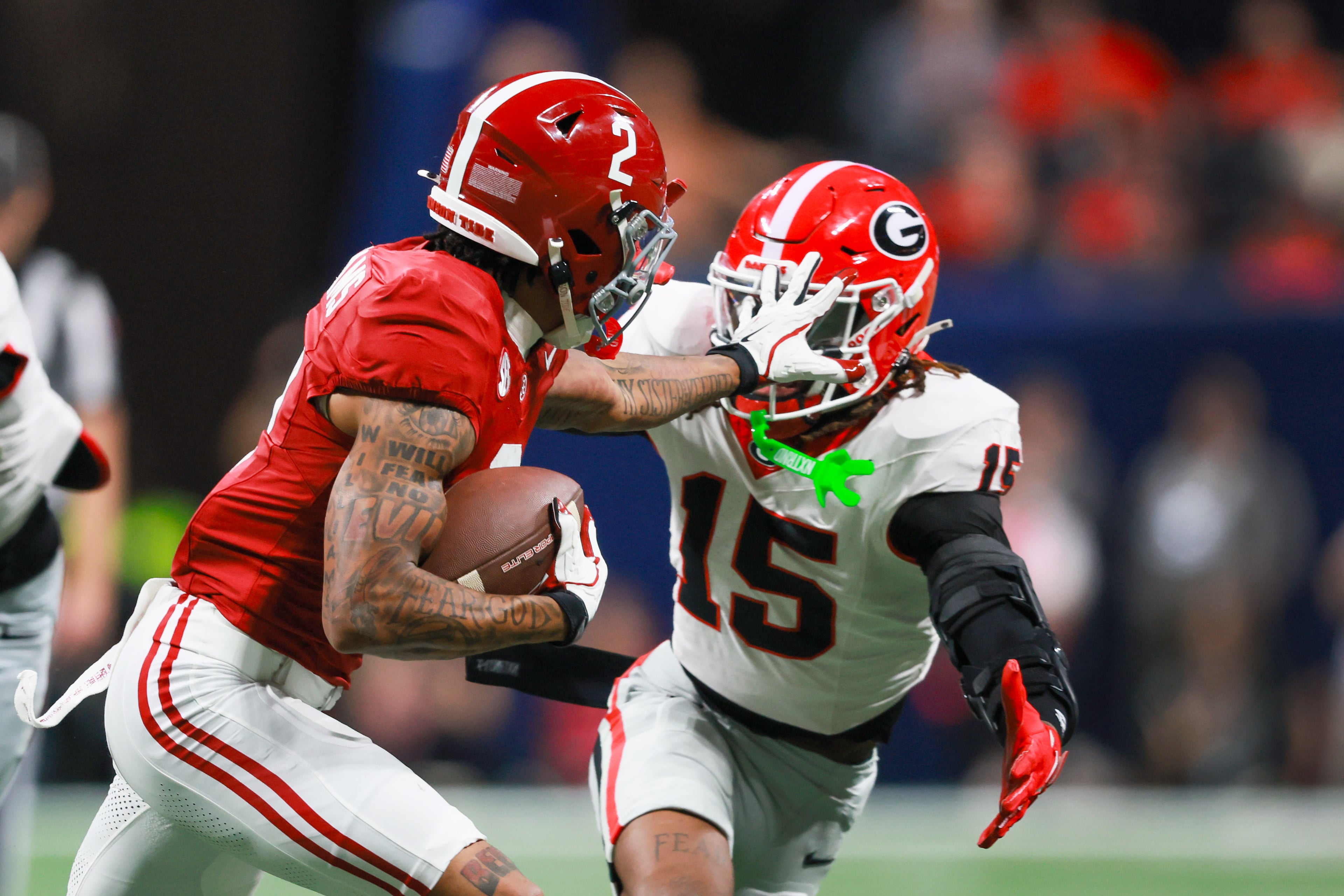 Alabama wide receiver Ryan Williams (2) pushes Georgia defensive back Demello Jones (15) away with a hand to the face during the first half of the SEC Championship game at Mercedes-Benz Stadium, Saturday, Dec. 6, 2025, in Atlanta. (Jason Getz / AJC)