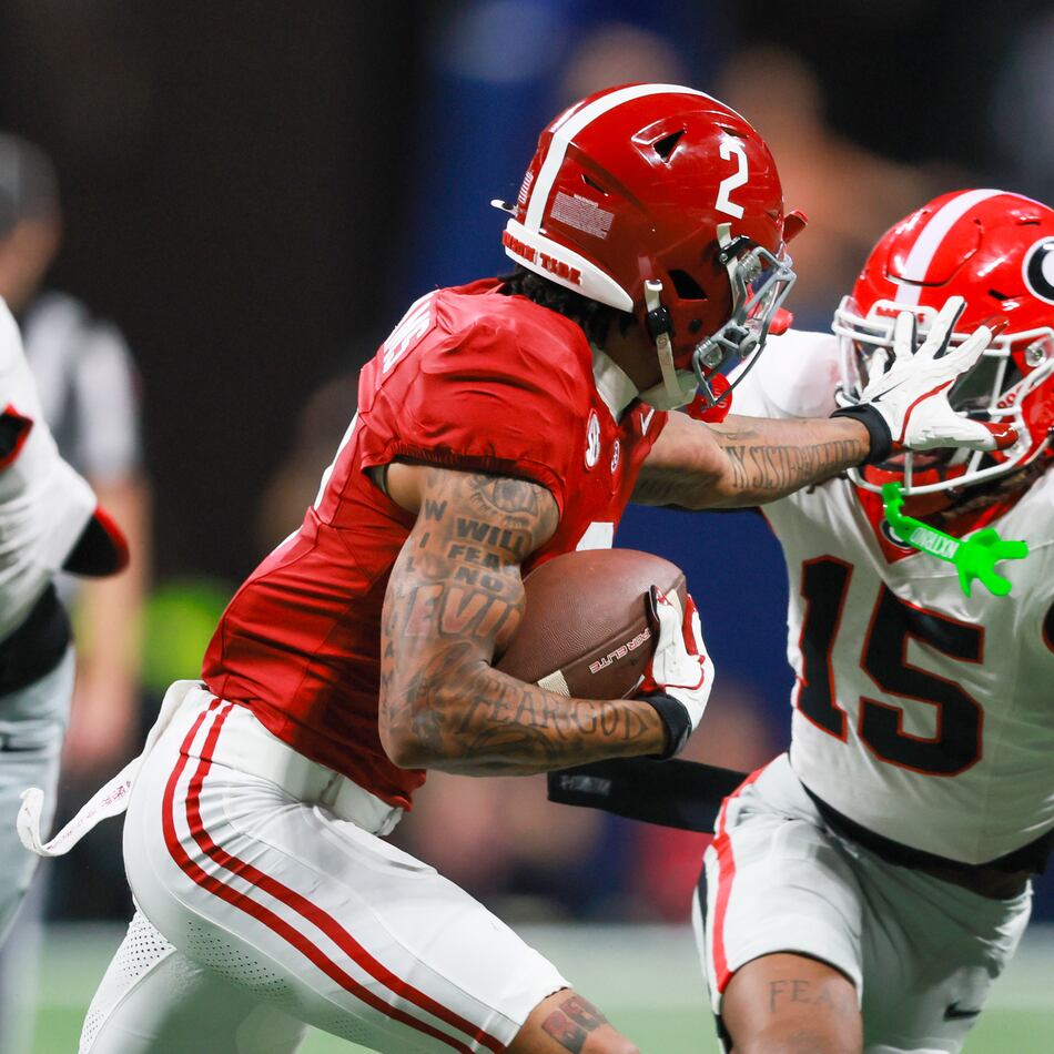 Alabama wide receiver Ryan Williams pushes Georgia defensive back Demello Jones away with a hand to the face during the first half of the SEC Championship game at Mercedes-Benz Stadium, Saturday, Dec. 6, 2025, in Atlanta. (Jason Getz/AJC)