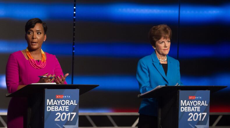 Atlanta mayoral contenders Keisha Lance Bottoms (left) and Mary Norwood speak at the WSB live debate on Sunday in Atlanta. STEVE SCHAEFER / SPECIAL TO THE AJC