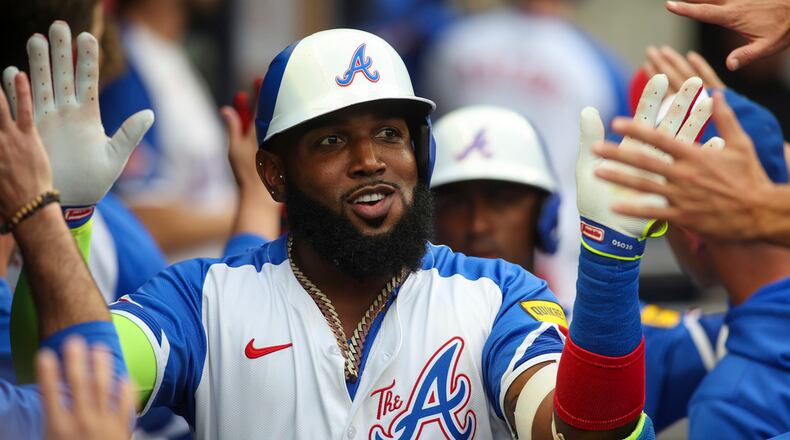 Atlanta Braves designated hitter Marcell Ozuna (20) celebrates with teammates after a two-run home run in the first inning of a baseball game against the Philadelphia Phillies, Saturday, July 6, 2024, in Atlanta. (AP Photo/Brett Davis)