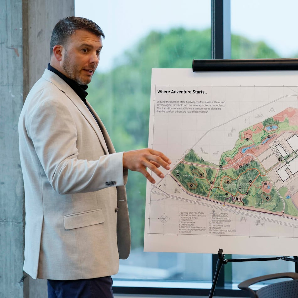 Jimmy Knauf, executive vice president of facilities at Rivian, describes the design of the Stanton Springs plant, based on a rendering, after touring Rivian’s East Coast headquarters in Atlanta on Tuesday, Aug. 4, 2026. (Miguel Martinez/AJC)