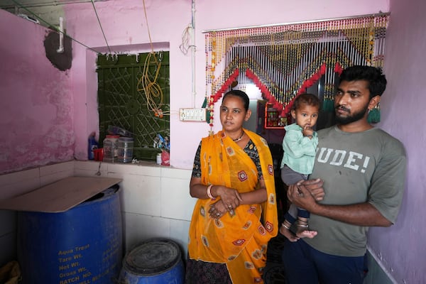 Akashbhai Thakor, right, and his wife Kumud stand at their house in Ahmedabad, India, Thursday, April 3, 2025. (AP Photo/Ajit Solanki)