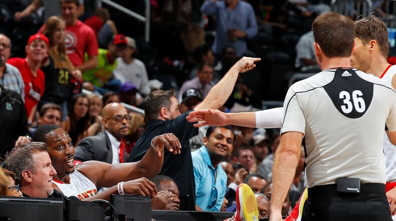 Dwight Howard of the Hawks reacts after diving across the scorer’s table while chasing a loose ball against the New Orleans Pelicans at Philips Arena on October 18, 2016 in Atlanta, Georgia. Photo by Kevin C. Cox/Getty Images)