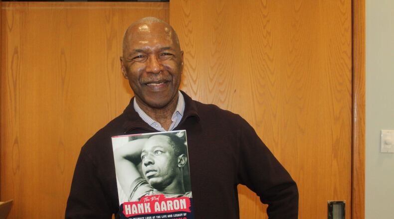 Longtime Atlanta sports writer Terence Moore holds a copy of his book, "The Real Hand Aaron: An Intimate Look at the Life and Legacy of the Home Run King," on Saturday at the Smyrna Public Library. (Photo Courtesy of Brian McKeithan)