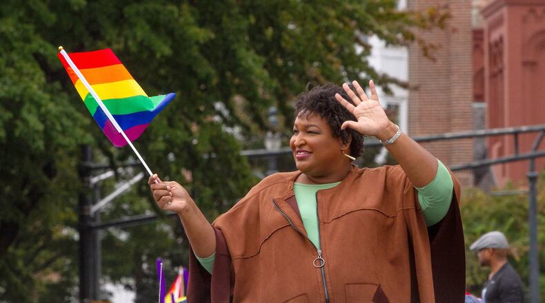 Stacey Abrams waves a rainbow flag as she makes her way down Peachtree Street during the 49th Annual Pride Festival and Parade in Atlanta Sunday, Oct 13, 2019. STEVE SCHAEFER / SPECIAL TO THE AJC