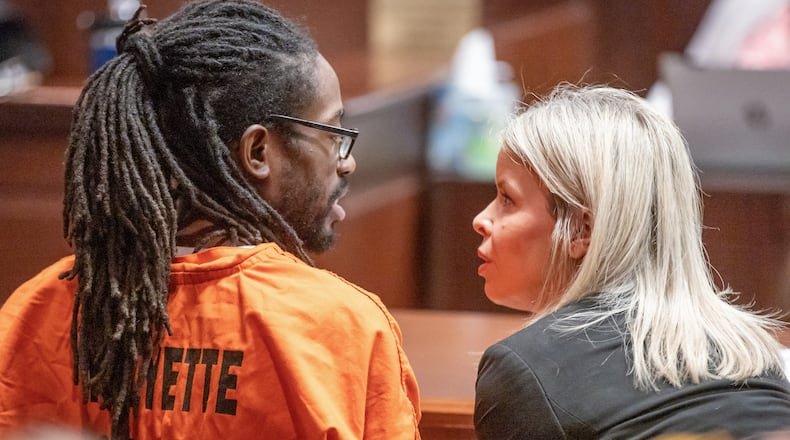 Black Hammer leader Augustus Claudius Romain Jr., 36, known as Gazi Kodzo, talks with his attorney Stacey Flynn after his hearing at the County Justice Center in Fayetteville Wednesday, August 17, 2022. Steve Schaefer/steve.schaefer@ajc.com)