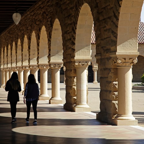 FILE - Students walk through the Stanford University campus, March 14, 2019, in Santa Clara, Calif. (AP Photo/Ben Margot, File)