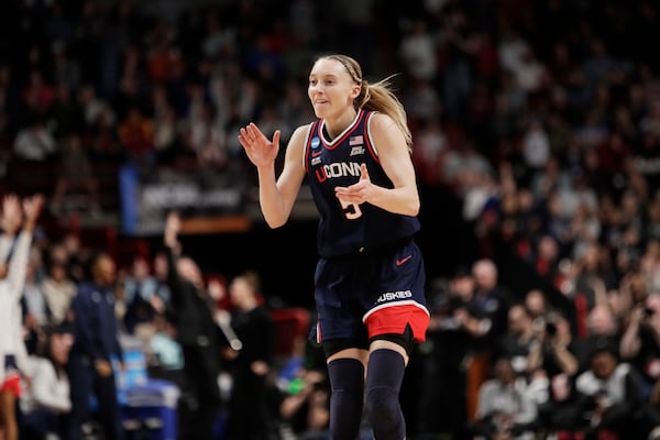 UConn guard Paige Bueckers (5) celebrates scoring a basket during the first half against Southern California in the Elite Eight of the NCAA college basketball tournament, Monday, March 31, 2025, in Spokane, Wash. (AP Photo/Young Kwak)