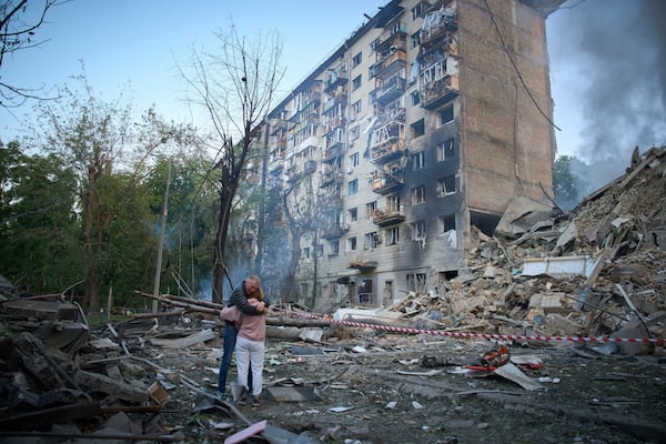 Residents react after a Russian missile hit a multi-storey apartment during Russia's combined missile and drone air attack in Kyiv, Ukraine, Tuesday, June 17, 2025. (AP Photo/Efrem Lukatsky)