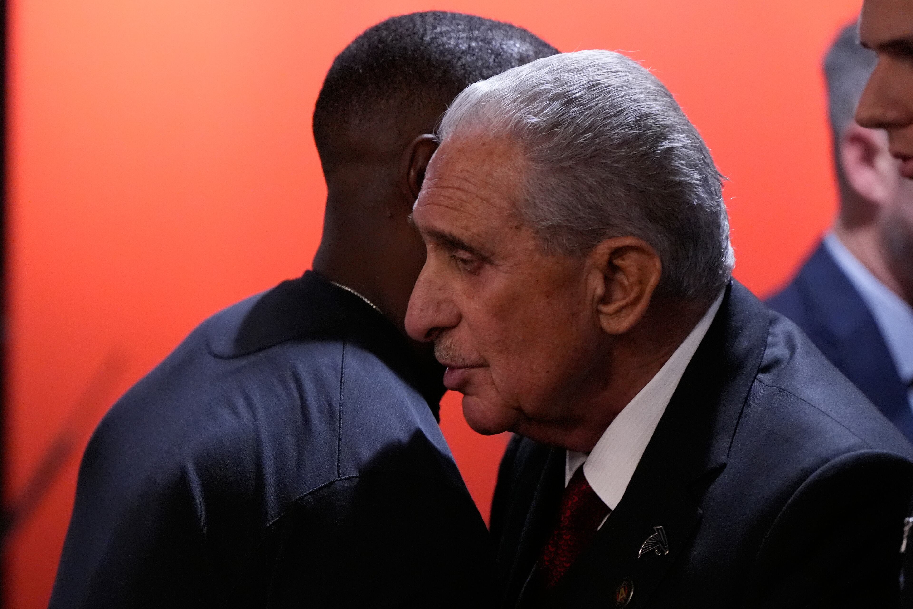 Falcons owner Arthur Blank (right) greets head coach Raheem Morris after Sunday's loss to Seattle.