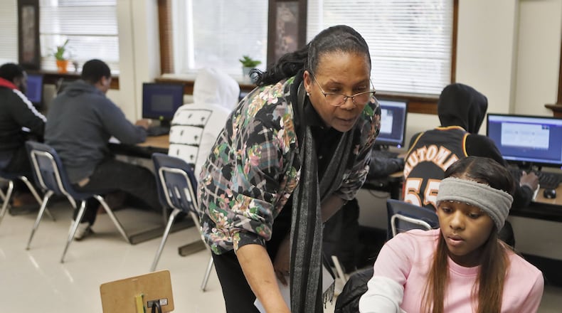 Phoenix Academy Principal Evelyn Mobley checks the progress dashboard of Tiana Mathis, 19, in a Nov. 12, 2019, social studies class, where the students work independently under a teacher’s supervision. Atlanta Public Schools merged its alternative high school programs into the Phoenix Academy, which launched this school year. The academy offers a food pantry, a nursery for children of students, and a clothing boutique, where students can get needed supplies and clothes to wear to job interviews. BOB ANDRES / ROBERT.ANDRES@AJC.COM