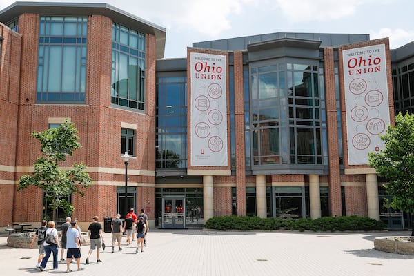 FILE -Pedestrians walk up to the The Ohio State University's student union, Saturday, May 18, 2019, in Columbus, Ohio. (AP Photo/John Minchillo, File)
