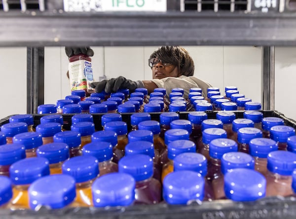 Volunteer Tonni Gillis take pride in making certain that the cooler at the Atlanta Community Food Bank is stocked and aesthetically pleasing. PHIL SKINNER FOR THE ATLANTA JOURNAL-CONSTITUTION
