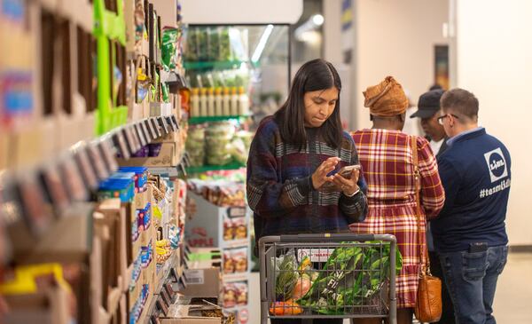 A customer shops at a Lidl grocery store on Northside Drive. (Jenni Girtman for the AJC 2025)