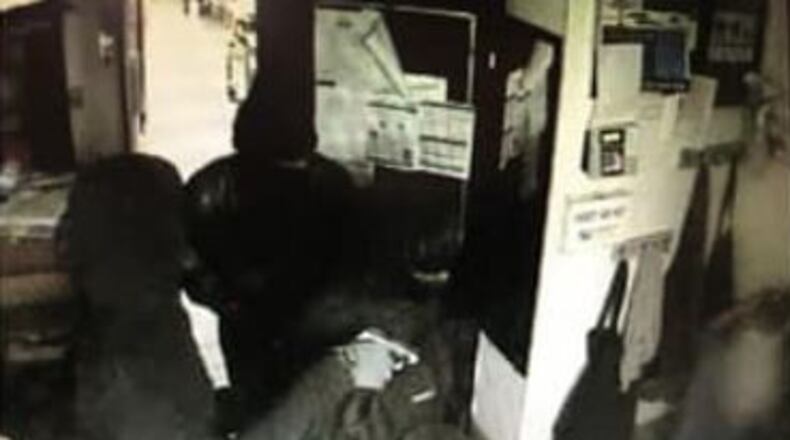 The men and a woman wore dark clothing as they robbed the Waffle House restaurant.