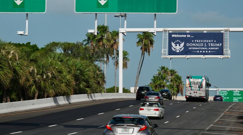 Airport visitors drive under a sign displaying the name of the rebranded Donald J. Trump International Airport in West Palm Beach, Fla., Thursday, July 9, 2026. (AP Photo/Cody Jackson)