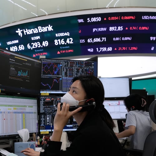 A currency trader talks on the phone at the foreign exchange dealing room of the Hana Bank headquarters in Seoul, South Korea, Monday, Aug. 10, 2026. (AP Photo/Ahn Young-joon)
