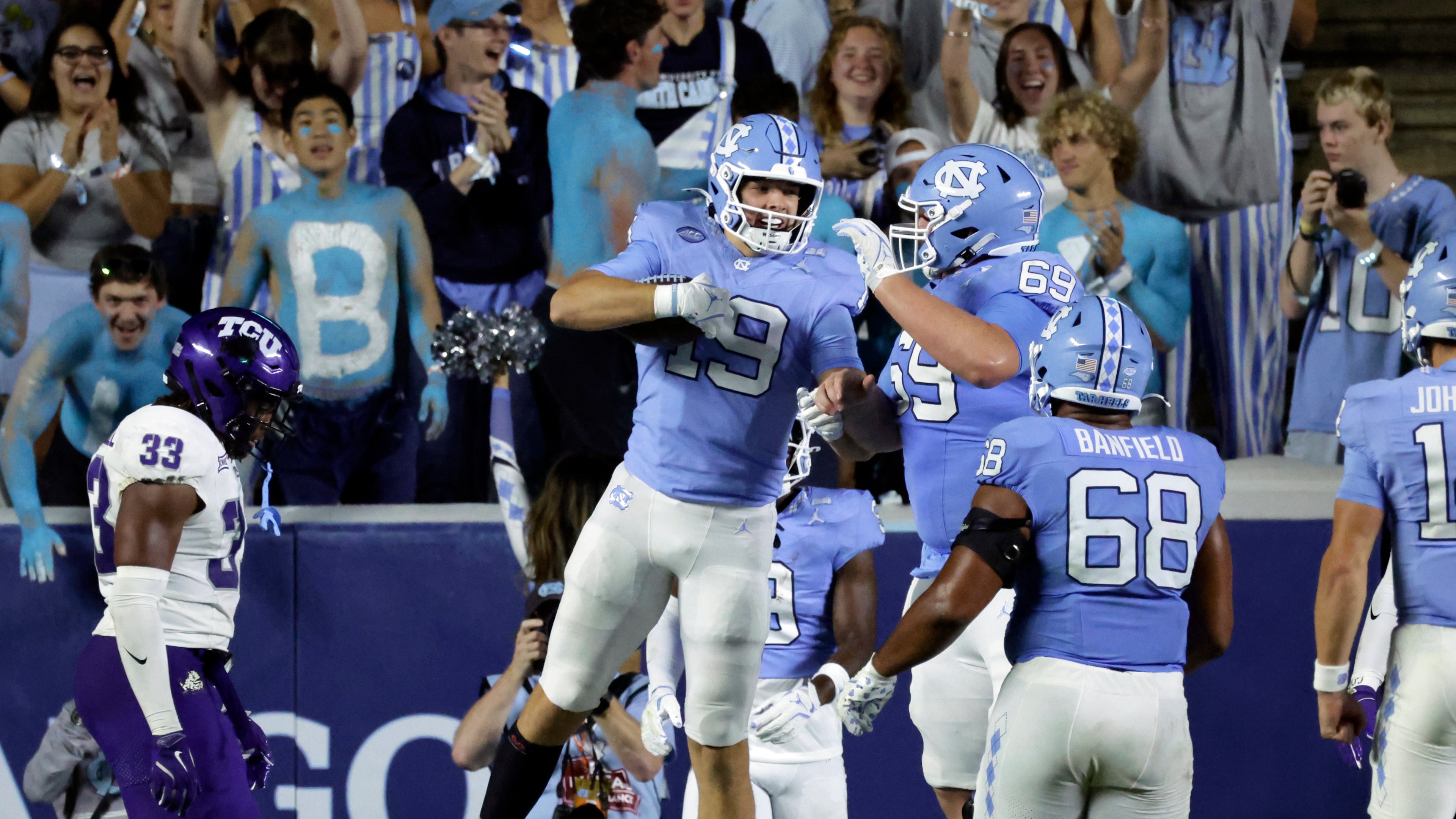 North Carolina tight end Jake Johnson (19) celebrates his touchdown with offensive linemen Chad Lindberg (69) and Aidan Banfield (68) during the second half of an NCAA college football game against TCU, Monday, Sept. 1, 2025, in Chapel Hill, N.C. (AP Photo/Chris Seward)