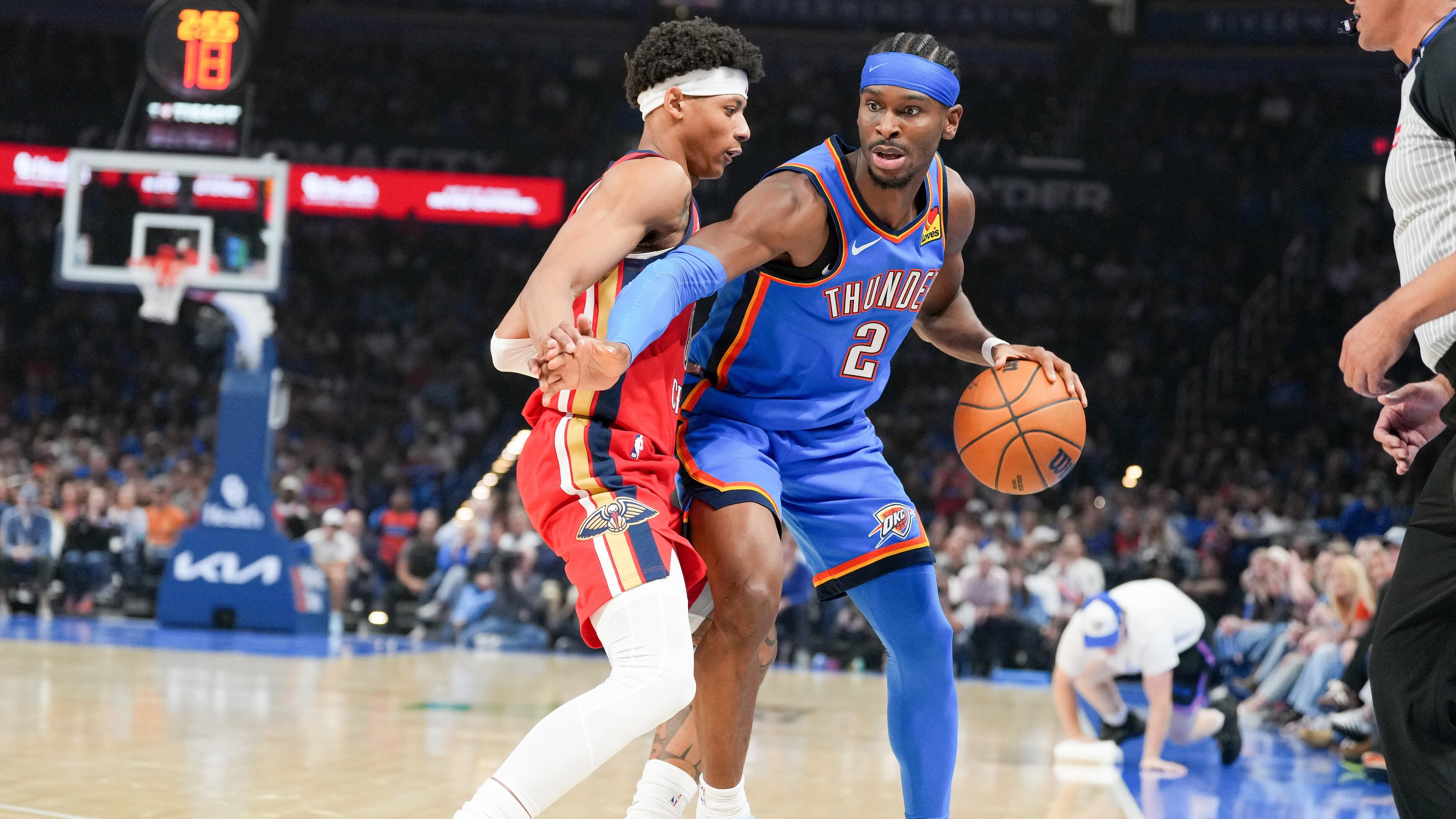 Oklahoma City Thunder guard Shai Gilgeous-Alexander (2) pushes past New Orleans Pelicans guard Jeremiah Fears, left, during the first half of an NBA basketball game, Sunday, Nov. 2, 2025, in Oklahoma City. (AP Photo/Kyle Phillips)