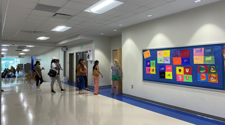 People enter the auditorium at David T. Howard Middle School in Atlanta, where a meeting took place on Thursday with parents, teachers and district officials. VANESSA McCRAY/AJC