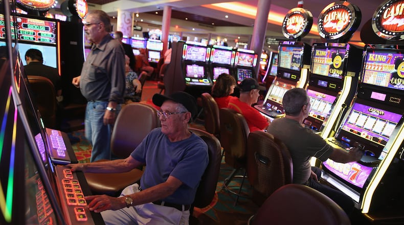 People play slot machines in a casino. (Photo by Joe Raedle/Getty Images)