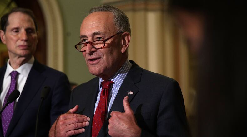 Who me? Supporting a poor tax? U.S. Senate Minority Leader Sen. Chuck Schumer (D-NY) gestures during a news briefing at the Capitol, Sept. 19. (Alex Wong / Getty Images)