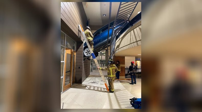 Atlanta fire crews rescued the woman who drove her SUV off a Buckhead parking garage Wednesday.