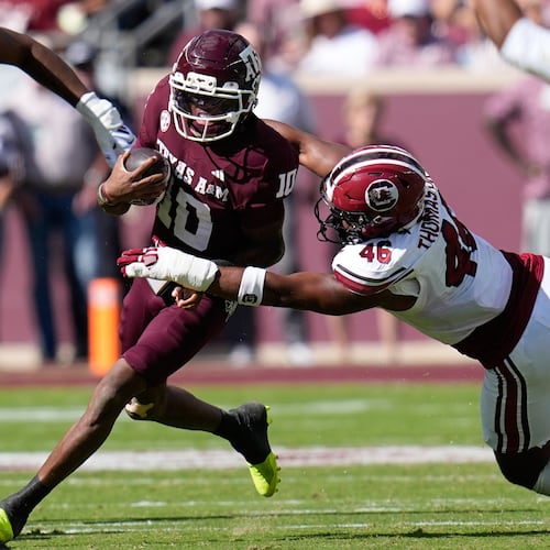 Texas A&M quarterback Marcel Reed (10) is tackled by South Carolina defensive end Bryan Thomas Jr. (46) during the first half of an NCAA college football game Saturday, Nov. 15, 2025, in College Station, Texas. (AP Photo/David J. Phillip)