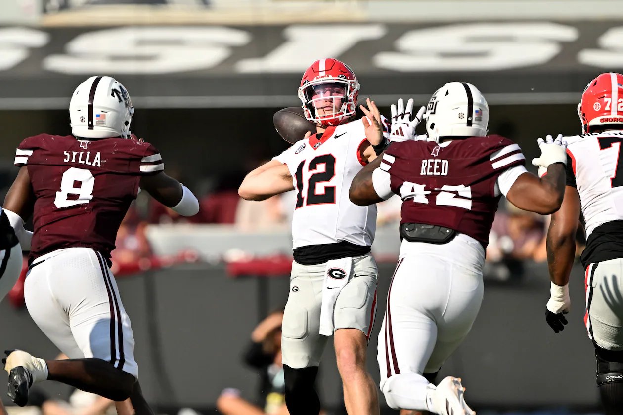 Georgia quarterback Ryan Puglisi (center) gets off a pass during the second half of a game against Mississippi State at Davis Wade Stadium, Saturday, Nov. 8, 2025, in Starkville, Mississippi. (Hyosub Shin/AJC)