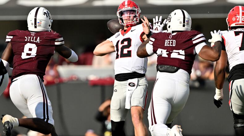 Georgia quarterback Ryan Puglisi (center) gets off a pass during the second half of a game against Mississippi State at Davis Wade Stadium, Saturday, Nov. 8, 2025, in Starkville, Mississippi. (Hyosub Shin/AJC)