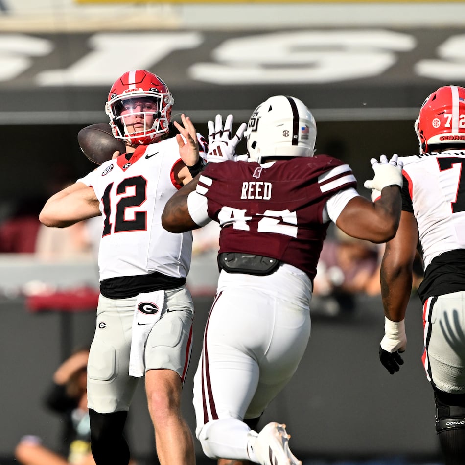 Georgia quarterback Ryan Puglisi (center) gets off a pass during the second half of a game against Mississippi State at Davis Wade Stadium, Saturday, Nov. 8, 2025, in Starkville, Mississippi. (Hyosub Shin/AJC)