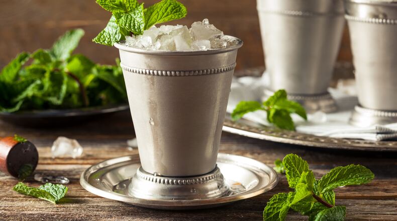 56016514 - cold refreshing classic mint julep with mint and bourbon