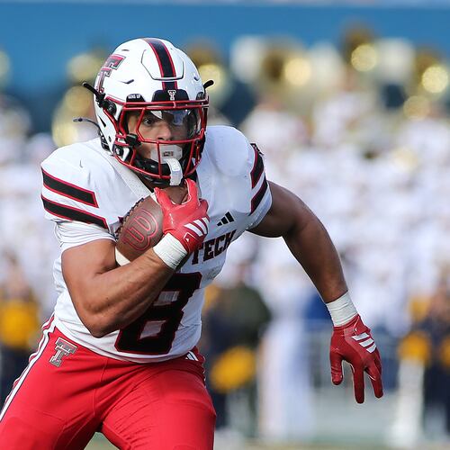 Texas Tech running back Cameron Dickey (8) runs against West Virginia during the first half of an NCAA college football game Saturday, Nov. 29, 2025, in Morgantown, W.Va. (AP Photo/Kathleen Batten)
