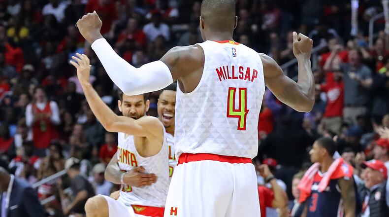 April 24, 2017, Atlanta: Atlanta Hawks Jose Calderon (from left), Kent Bazemore, and Paul Millsap celebrate scoring against the Washington Wizards with Bradley Beal watching on the way to a 111-101 victory in game 4 of a first-round NBA basketball playoff series on Monday, April 24, 2017, in Atlanta. Curtis Compton/ccompton@ajc.com