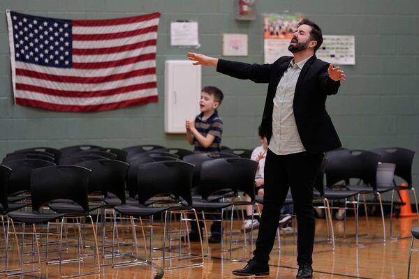 River Church Cincinnati pastor Cory Bowman, who is Vice President JD Vance's half brother and Cincinnati mayoral candidate, and RJ Symes, left, pray during Easter morning service in the Hays Porter Elementary School gym Sunday, April 20, 2025, in Cincinnati. (AP Photo/Carolyn Kaster)