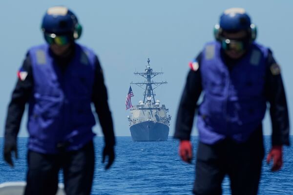Personnel on board the Philippine Navy BRP Jose Rizal check the flight deck as US Navy USS Shoup (DDG86) joins maneuvers during the Philippines United States Japan Multilateral Maritime Cooperative Activity off a disputed South China Sea shoal on Friday, March 28, 2025. (AP Photo/Aaron Favila)