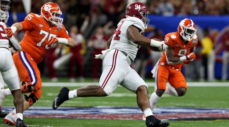 Alabama defensive lineman Da'Ron Payne (94) returns an interception in the second half of the Sugar Bowl semi-final playoff game against Clemson for the NCAA college football national championship, in New Orleans, Monday, Jan. 1, 2018. (AP Photo/Rusty Costanza)