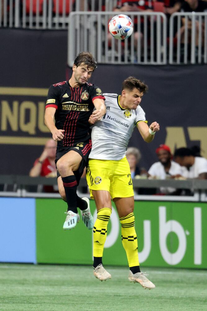 Atlanta United midfielder Santiago Sosa (5) heads the ball against Columbus Crew forward Miguel Berry (27). JASON GETZ FOR THE ATLANTA JOURNAL-CONSTITUTION