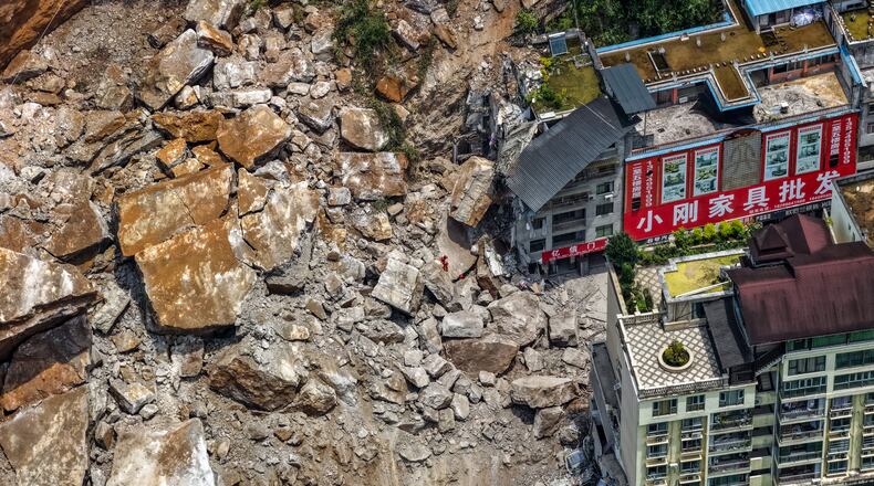 In this photo released by Xinhua News Agency, rescuers conduct search and rescue operation on the site of the landslide in Pengshui County in southwestern China's Chongqing on Friday, July 17, 2026. (Huang Wei/Xinhua via AP)