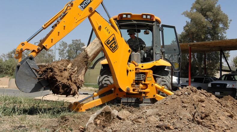 Stump removal headed to a landfill. (U.S. Air Force photo by Senior Airman SerMae Lampkin)