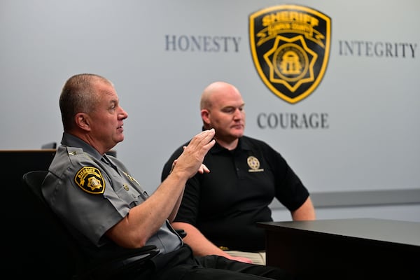 Lumpkin County Sheriff Stacy Jarrard (left) and criminal investigator Hasley Gipson talk about details of the cold case their department recently solved. (Daniel Varnado for the AJC)